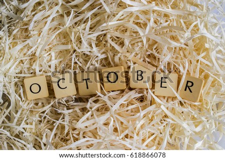 Block Letters of the month "October" word on wood shavings