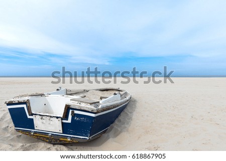Post Card Picture Of Old Broken Boat Lying On The Wide Lonely Beach