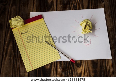 bright idea drawn paper pen notebook wood background