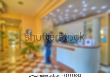 Picture blurred for background abstract and can be illustration to Reception area with reception desk in modern hotel