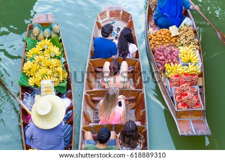 Tourists visiting by boat at Damnoen Saduak floating market in Ratchaburi near Bangkok, Thailand Royalty-Free Stock Photo #618889310