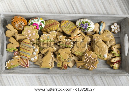 Easter homemade hand painted gingerbread cookies on grey wooden tray