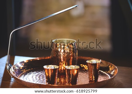 Copper Turk and cups for coffee on an iron tray.Shallow depth of field.