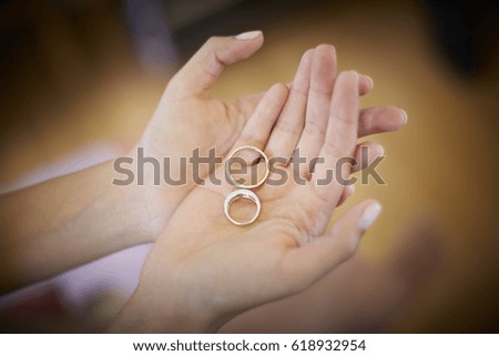 Woman hands holding engagement rings. Bride. Manicure. Close up picture. Vignette. Horizontal format.