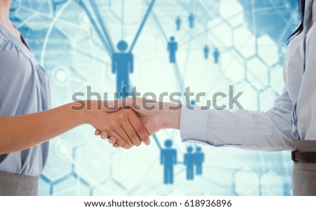 Businesswomen shaking hands against people icons and binary codes