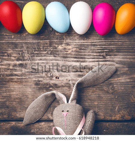 Easter bunny on old boards. Old board background. Rabbit. Easter ideas. Easter eggs. Space for text. Image in trendy toning.