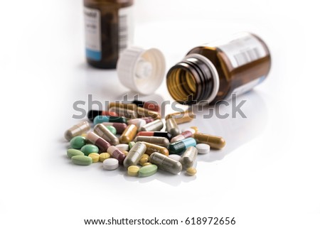 Medicines, supplements and drugs in a bottle on a white background
