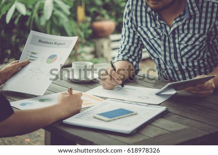 Business meeting time. Photo young businessman working with new start up project. tablet on wood table. Idea presentation, analyze plans. Vintage style.