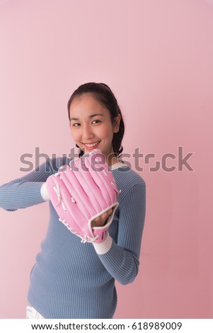 Beautiful woman with pink glove baseball equipment, isolated on pink background