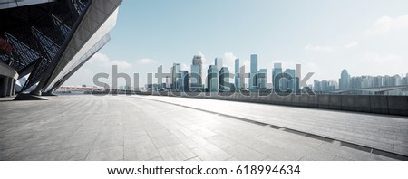 empty brick floor with cityscape of modern city