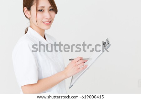 Young attractive asian nurse of the smile