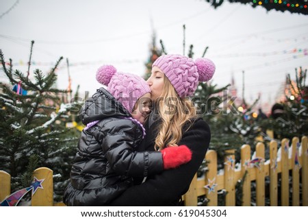 Mom and daughter at Christmas fair in Moscow