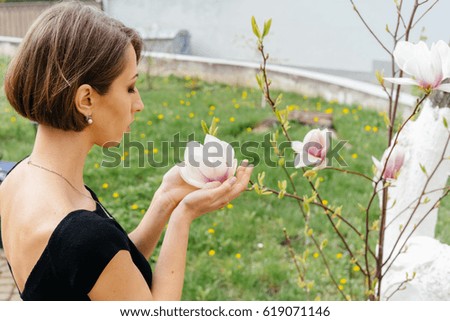 Flower white Magnolia in women's hands, close up
