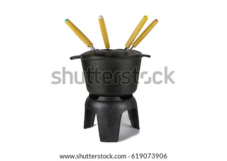 The fondue pig iron, black, with multi-colored forks. Royalty-Free Stock Photo #619073906