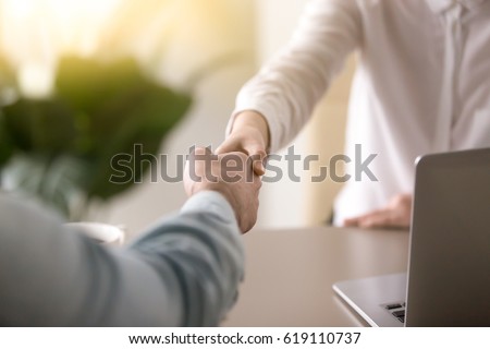 Close up of a handshake, male and female hands shaking as a symbol of effective negotiations, making agreement, greeting business partner or mutual respect and gender equality in relationships  Royalty-Free Stock Photo #619110737