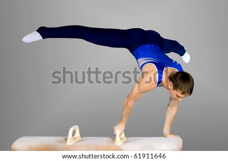 The sportsman the guy, carries out difficult exercise, sports gymnastics