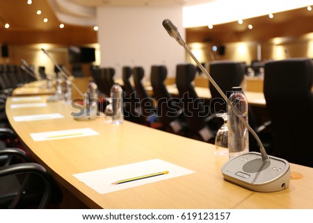 Close up one microphone in conference room and voice in room for background