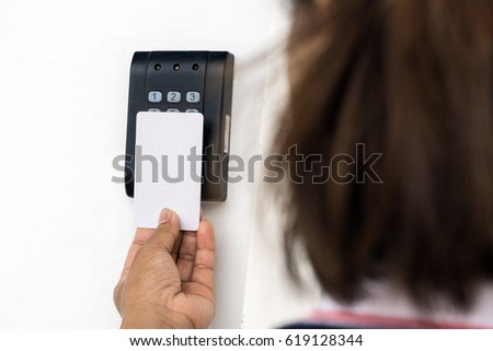 Door access control - woman holding a key card to lock and unlock door., Keycard touch the security system to access the door