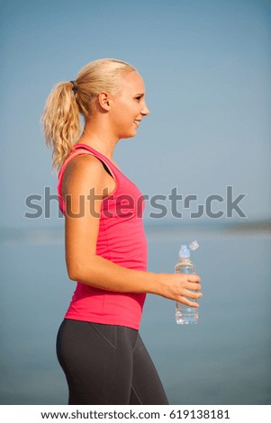 woman rests after morning workout on the beach