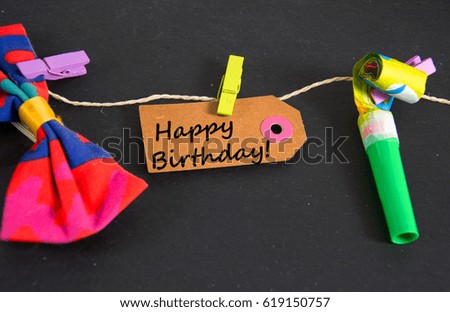 Happy Birthday written on a paper tag