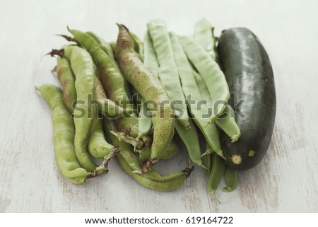 green fresh vegetables on white wooden background