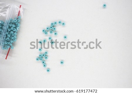 blue beautiful micro beads on white paper background