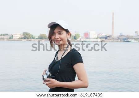 Hipster woman taking photos with retro film camera ,Girl Adventure Hangout Traveling Holiday Photography Concept