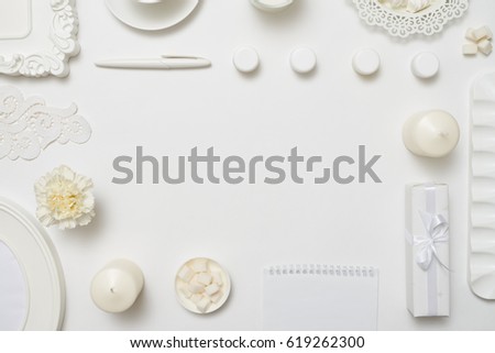 Overhead shot of a stylized desktop with notebook on white background 