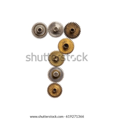 Vintage gears cogwheels steampunk style mechanical digit number seven. Rusty iron bronze metal texture shape 7. Aged mechanism wheels transmission connection concept. White background, close-up