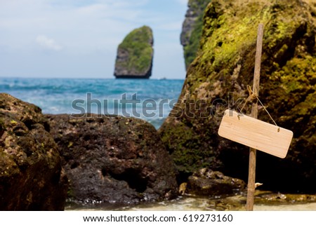 Close-up of the empty hanging banner on the bamboo stick with background of the beautiful view of the Temeling area Bay. Nusa Penida island, Indonesia.