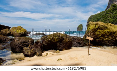 Empty hanging banner on the bamboo stick with background of the beautiful view of the Temeling area Bay. Nusa Penida island, Indonesia.