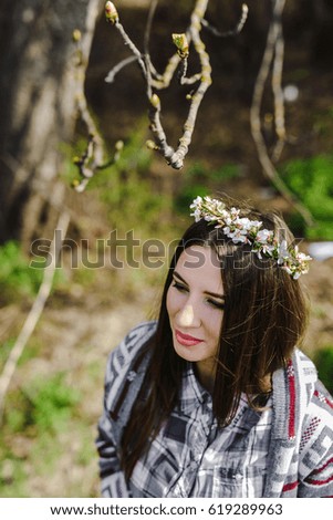 beautiful girl with a wreath of cherry blossoms 