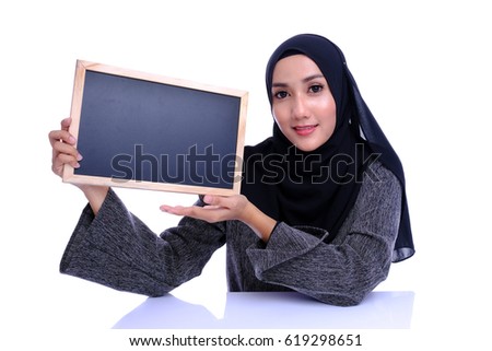 Pretty young woman holding empty blank board. Colorful studio portrait with white background.