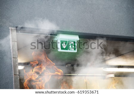 Emergency Fire Exit with smoke and fire flames