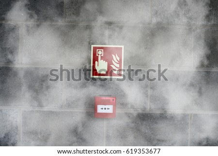 Emergency Fire Exit on the stone wall with fire  smoke
