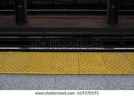 yellow safety edge on subway platform