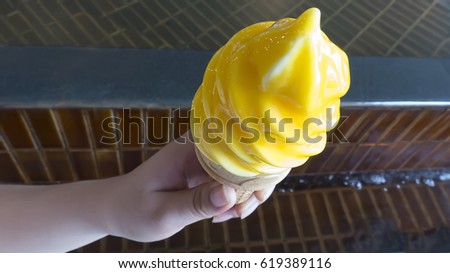 Woman holding ice cream mango to eat,blur,blurred,soft focus,motionblur