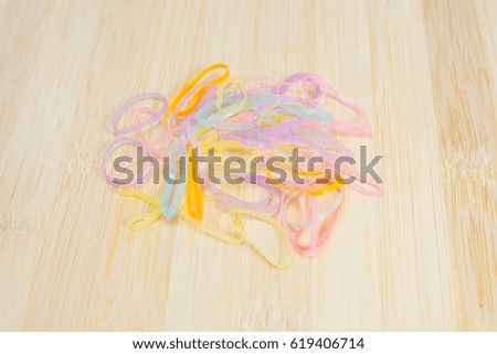 Colorful rubber bands  for girl hair on  wooden background