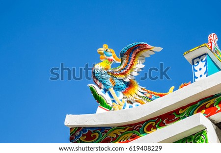 Chinese swan statue in the corner roof with blue sky