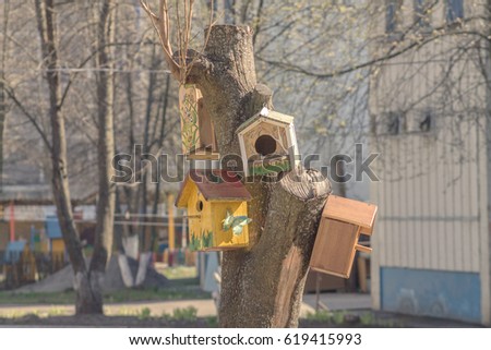 Bird skyscraper (after winter all birds fly home and this big and cozy house will accept them with joy) Royalty-Free Stock Photo #619415993