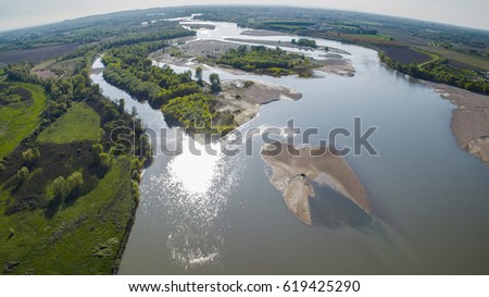 aerial view of river crossing countryside landscape in italy