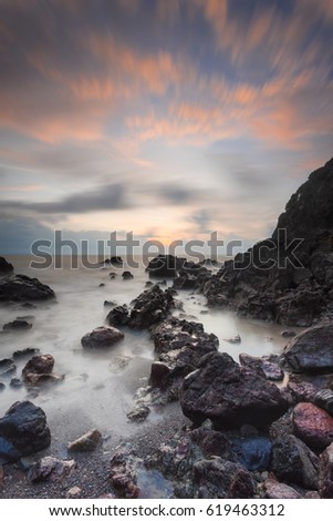 long exposure during sunrise at Mawar island Mersing Johor Malaysia.This image may contain noise, blurry clouds due to long exposure and low light, soft focus and poor lighting