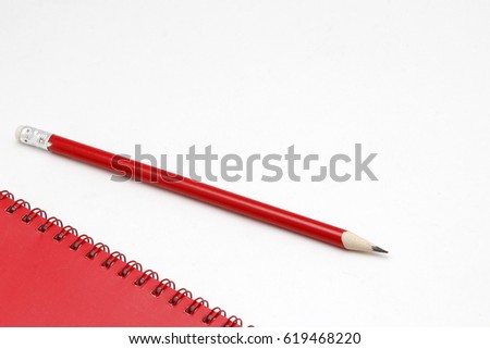Red notebook pen and pencil