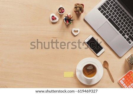 Office stuff and it gadgets display on top view business desk with copy space at text of picture. Creative table, modern project. Business mockup at empty laptop smartphone device on wood background.