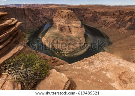 Wide-angle view of Horseshoe Bend, a horseshoe-shaped meander of the Colorado River located near the town of Page, in beautiful sunny day, Arizona, USA