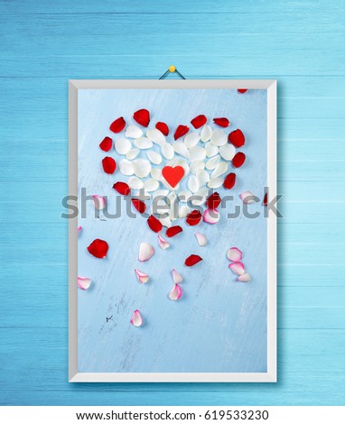 Heart of red, white rose petals on blue painted rustic background. Valentines day or love concept. Fresh natural flowers. Dirty grunge wooden board. Photo frame on wooden rustic wall.
