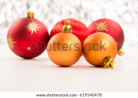 Closeup of golden and red Christmas balls on a white background