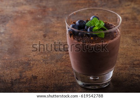 Chocolate pudding with berries and herbs, rustic food styled picture, for your advertisement
