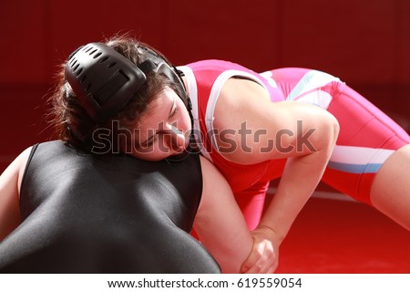 Female wrestler looking to score from a front headlock position