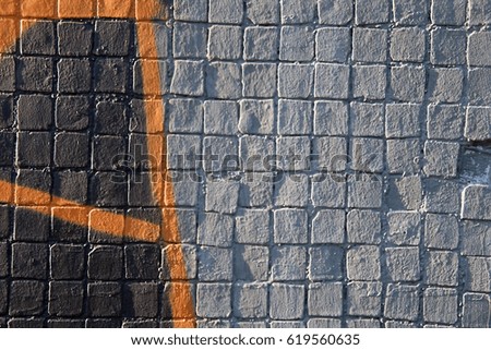 Painted gray mosaic brick tile wall, close up of graffiti texture, with vibrant colors for creativity, imaginative backgrounds and ideas.
